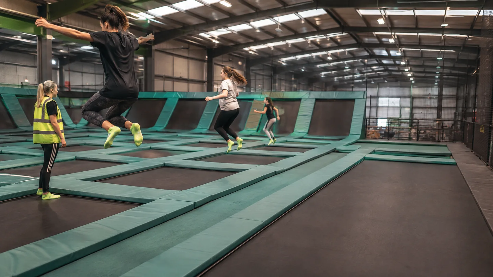 Children bounce across an indoor trampoline park floor in Ireland