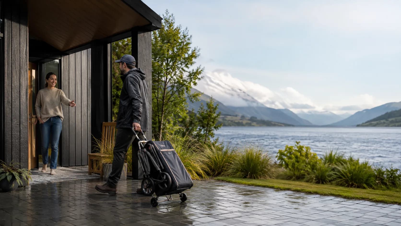 Team delivering folded baby gear to a New Zealand lakeside bach