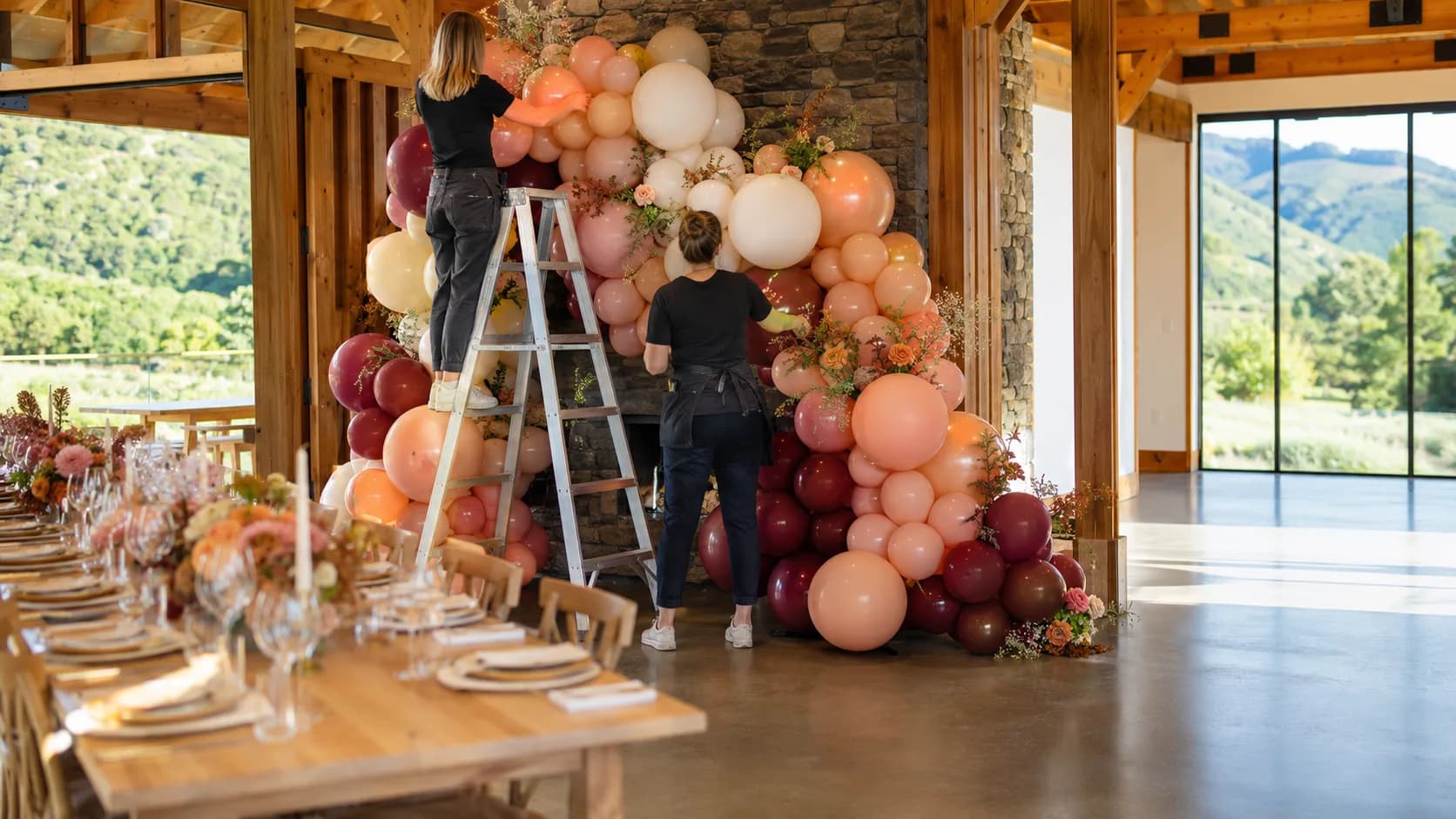 Balloon stylist installing colourful event decor for a booked celebration in New Zealand