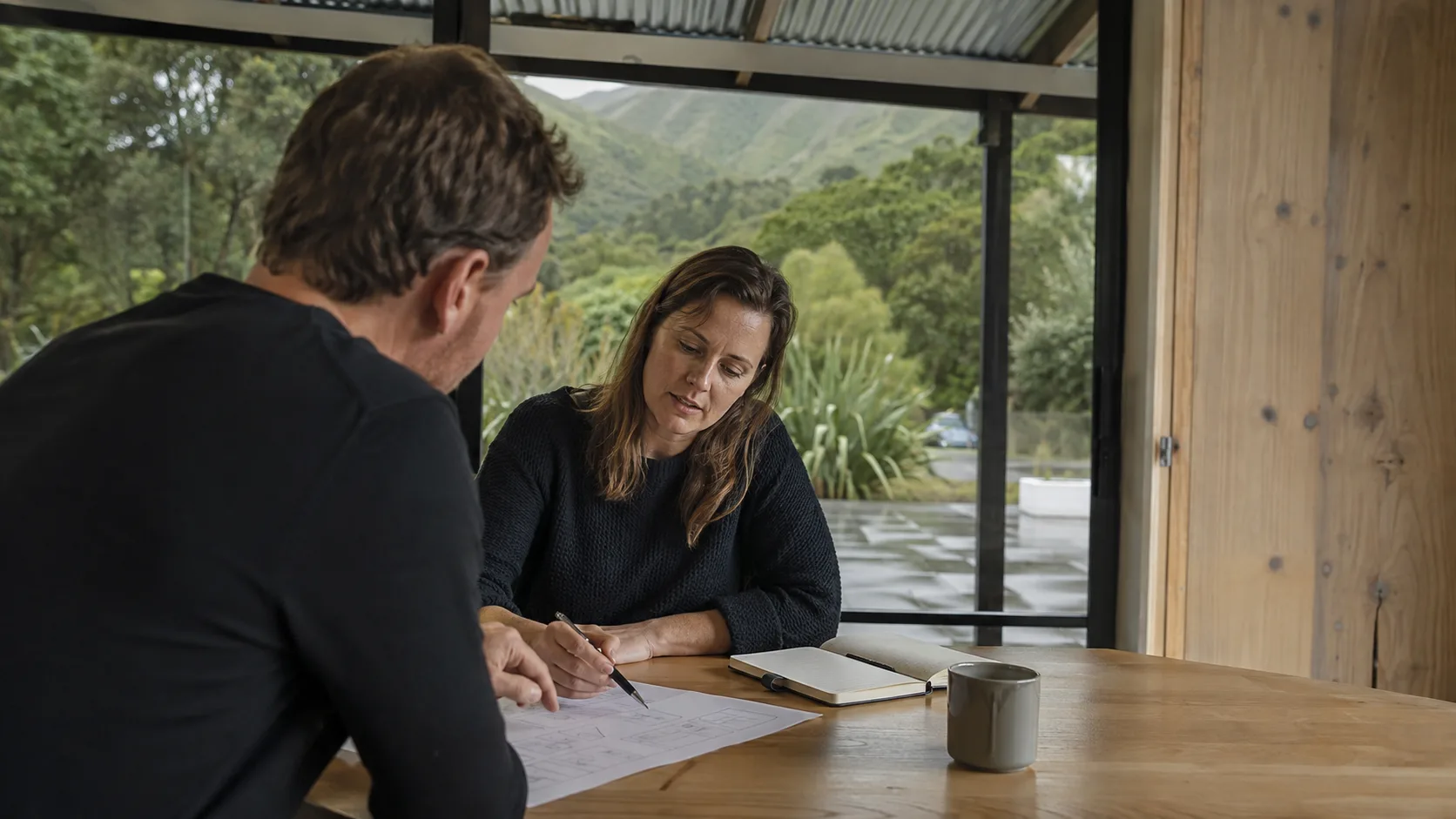 A business coach works through priorities with an owner in New Zealand