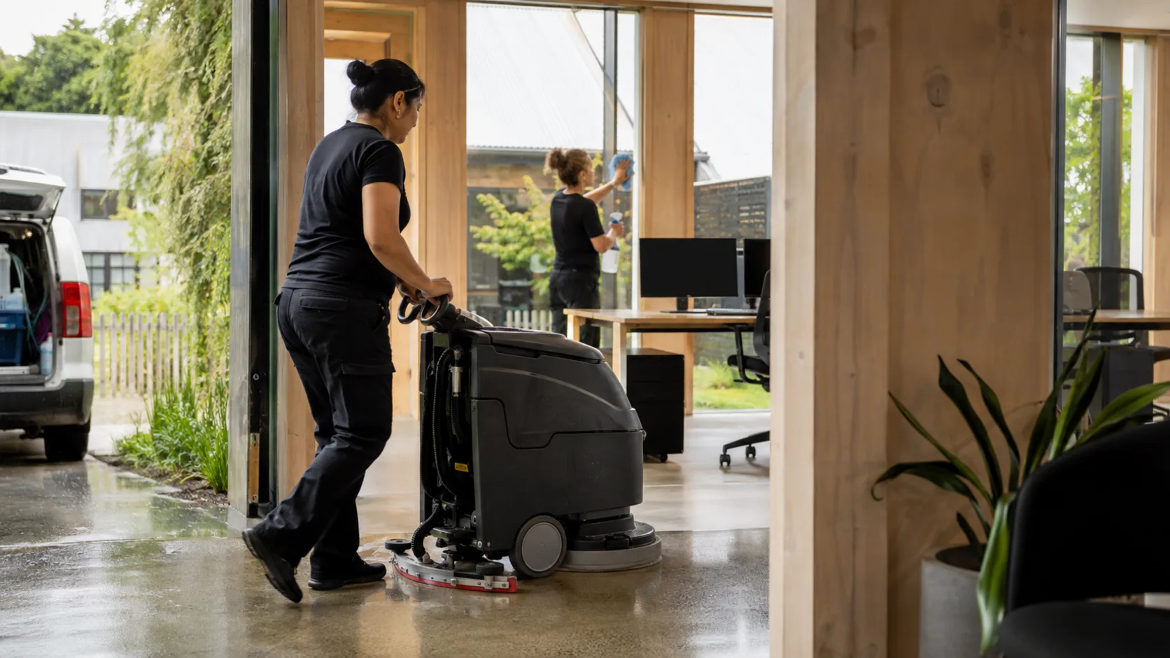 A commercial cleaner working through an office after hours in New Zealand