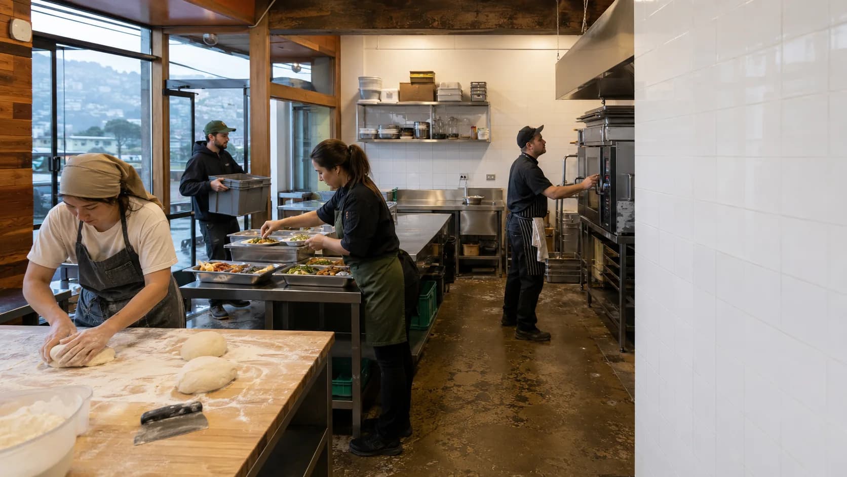 Food producers work across a busy shared kitchen during preparation
