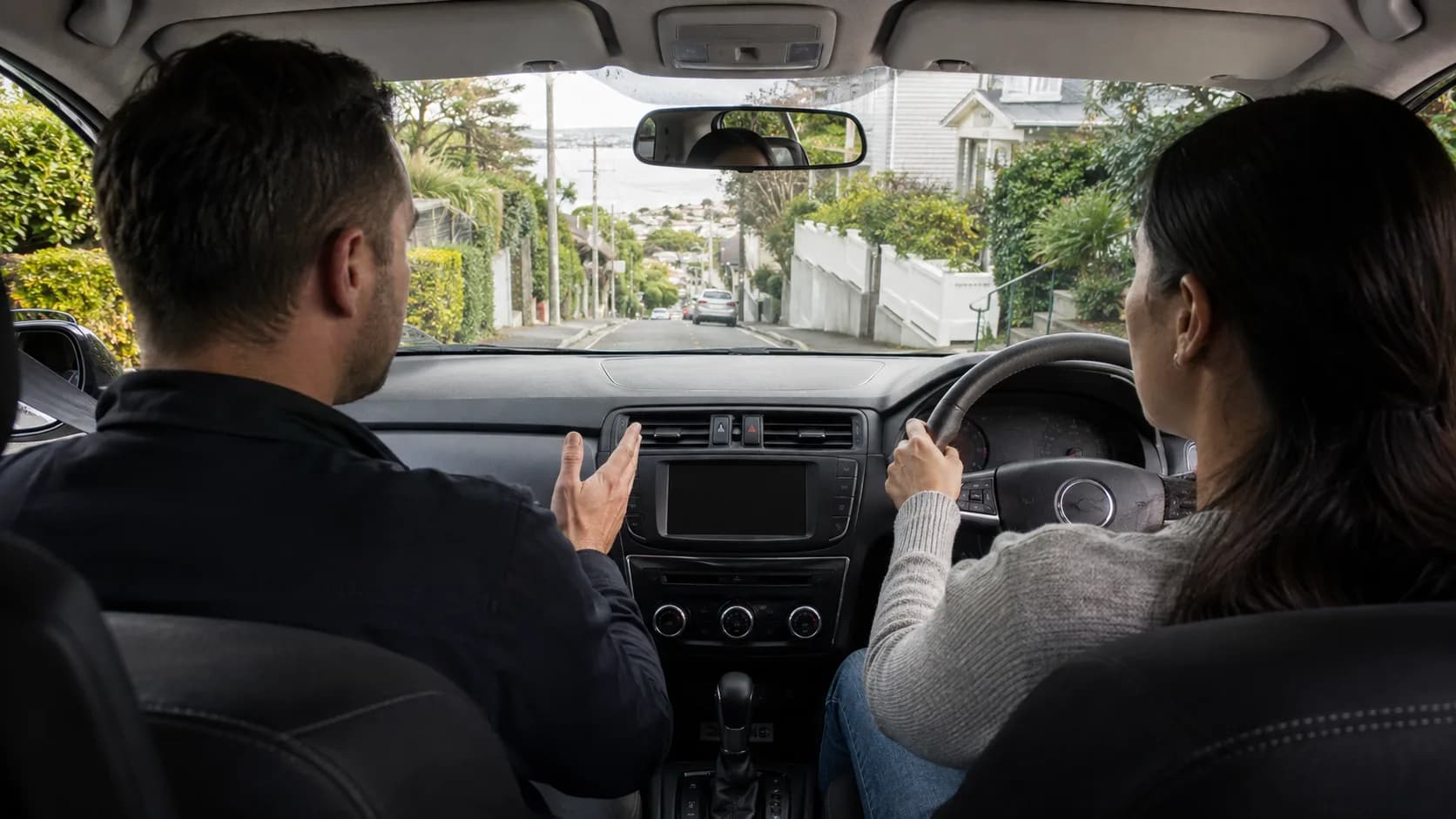 A driving instructor and learner on a lesson in New Zealand