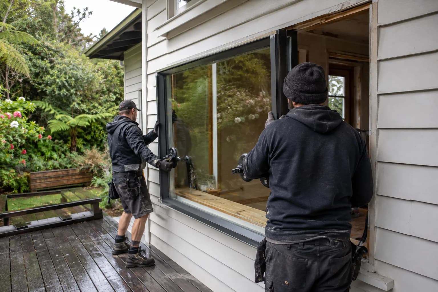 A glazier fitting a replacement pane in New Zealand