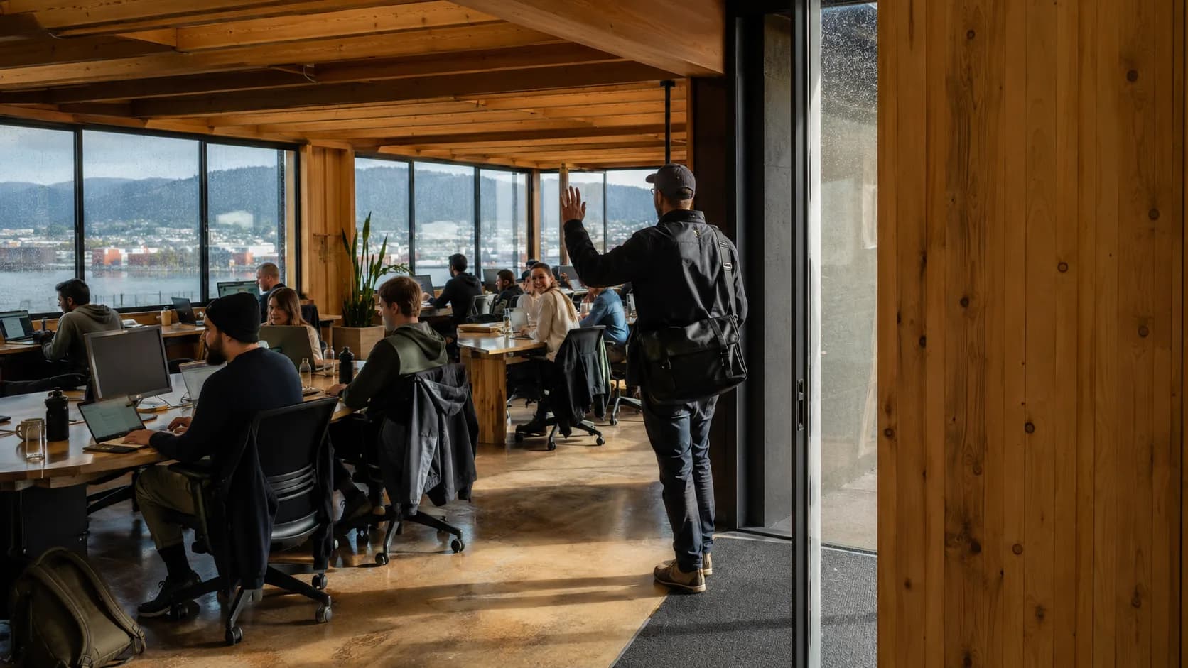 Coworkers use occupied desks throughout a bright professional shared workspace