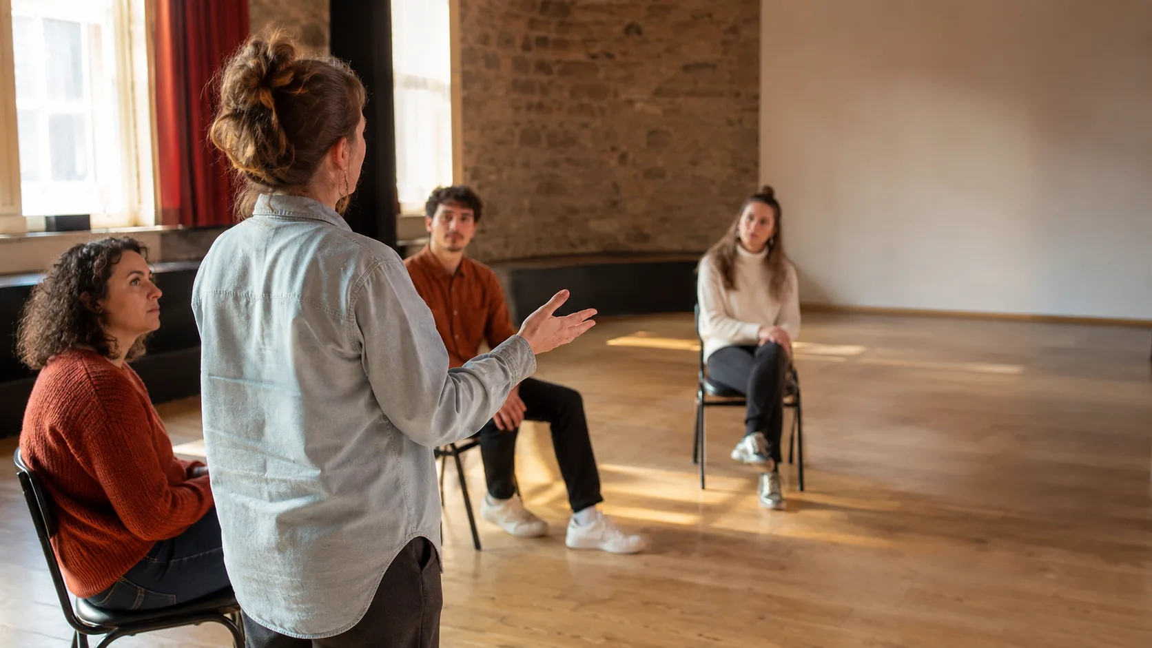 Improvisation class sharing a scene in a New Zealand theatre room