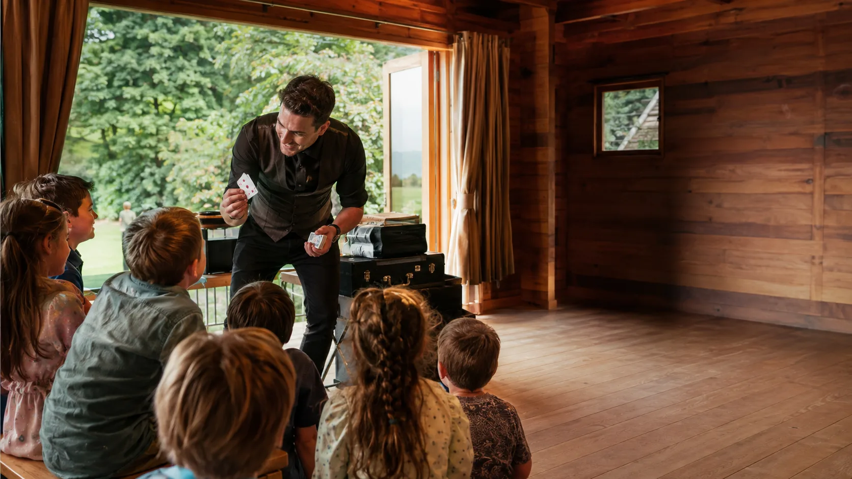 Magician performing close-up magic for delighted event guests in New Zealand