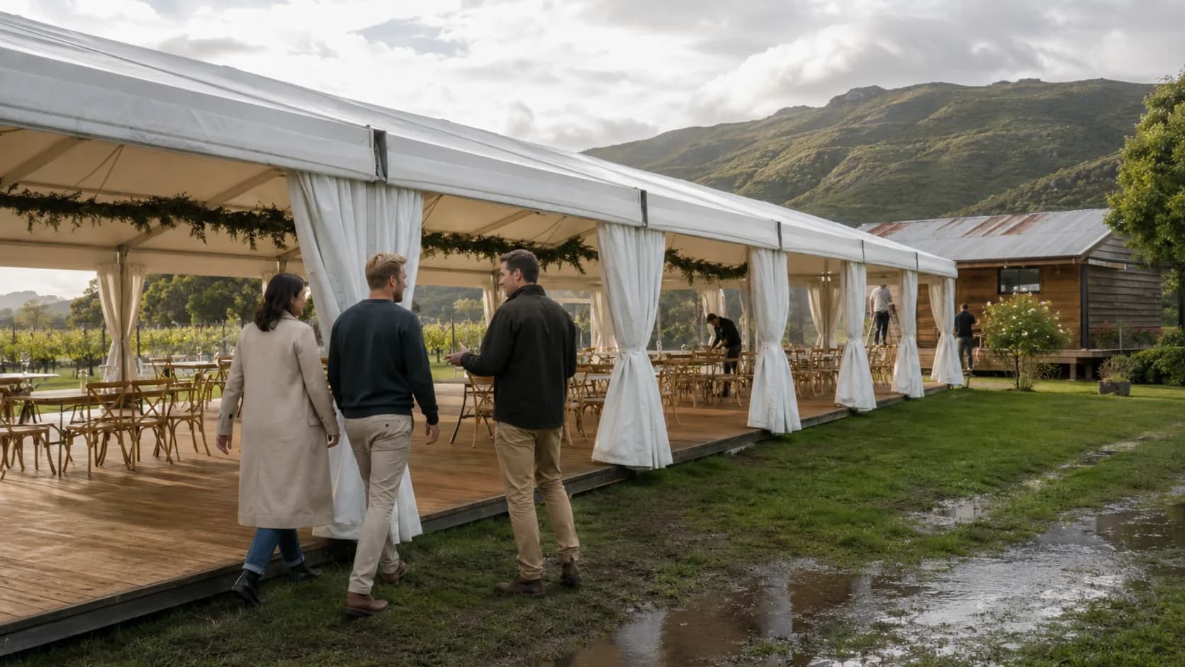 Customers inspecting a lakeside marquee after rain in New Zealand