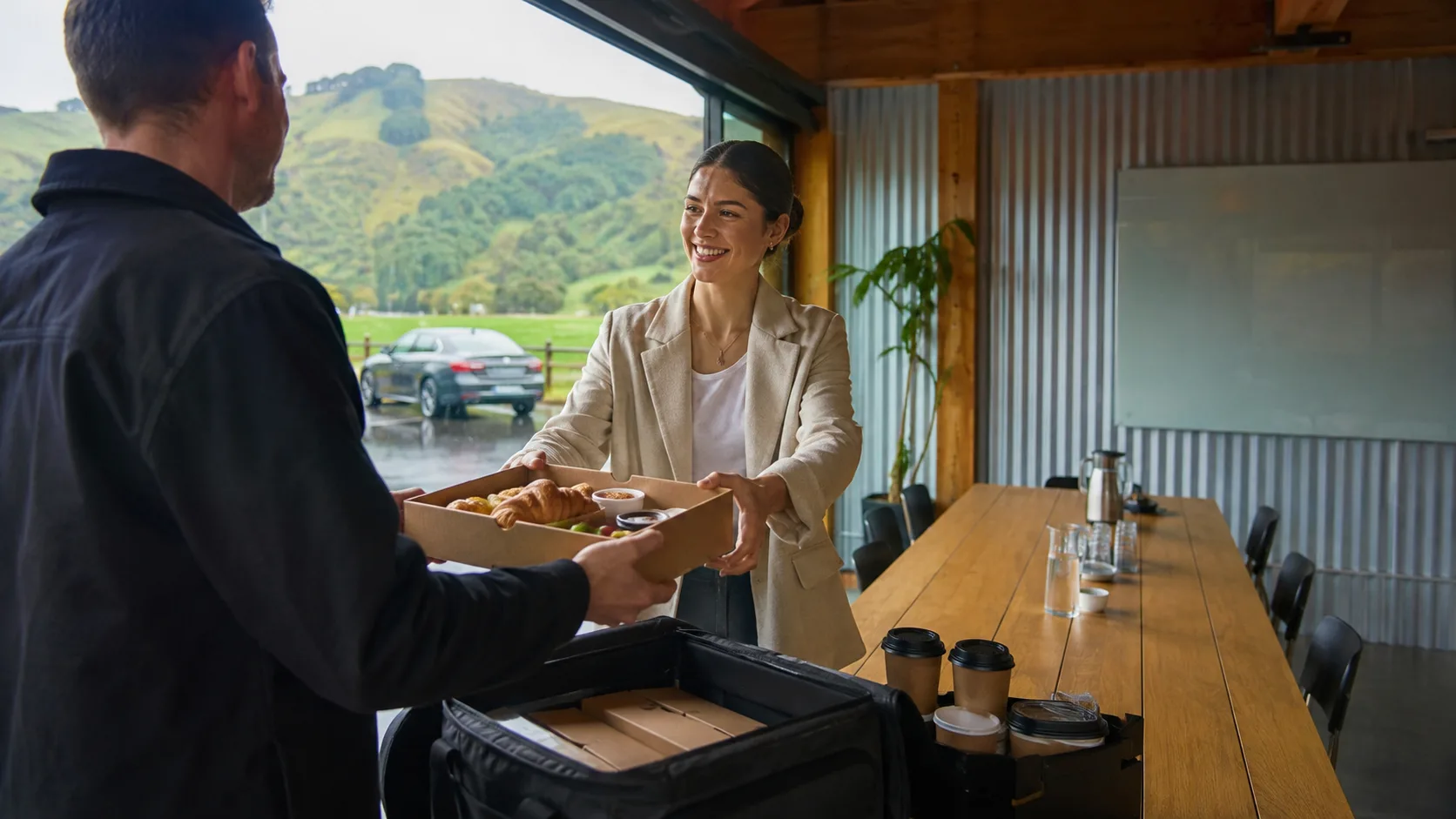 New Zealand caterer delivering breakfast to a rainy timber coworking venue