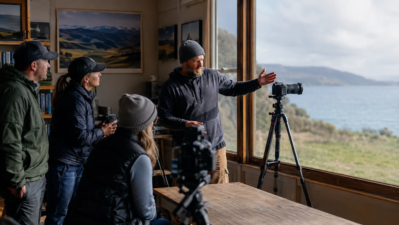 Photographer teaching a landscape workshop beside a New Zealand waterfront