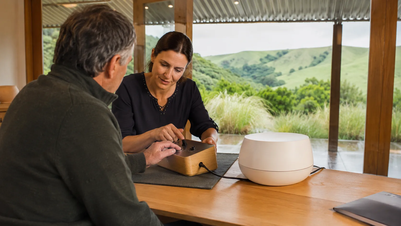 A product specialist demonstrates a device to a customer in New Zealand