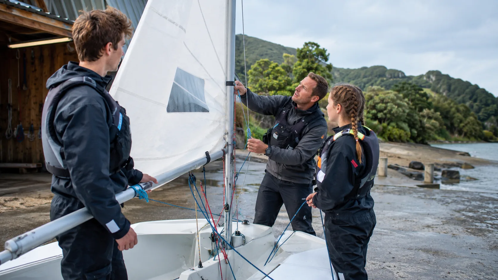 Learners rig a sailing dinghy at a New Zealand club slipway