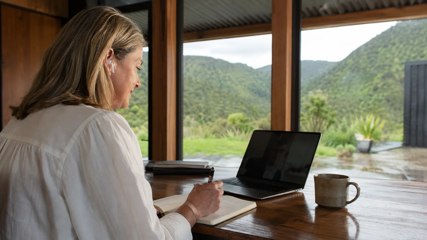 A sales professional takes notes during a scheduled video call in New Zealand