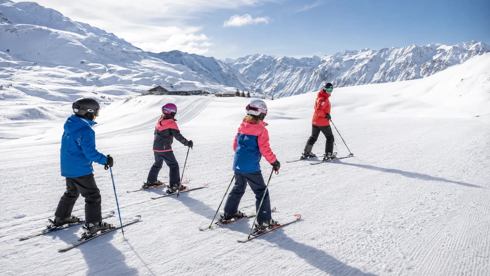 Ski school group following an instructor on a New Zealand mountain