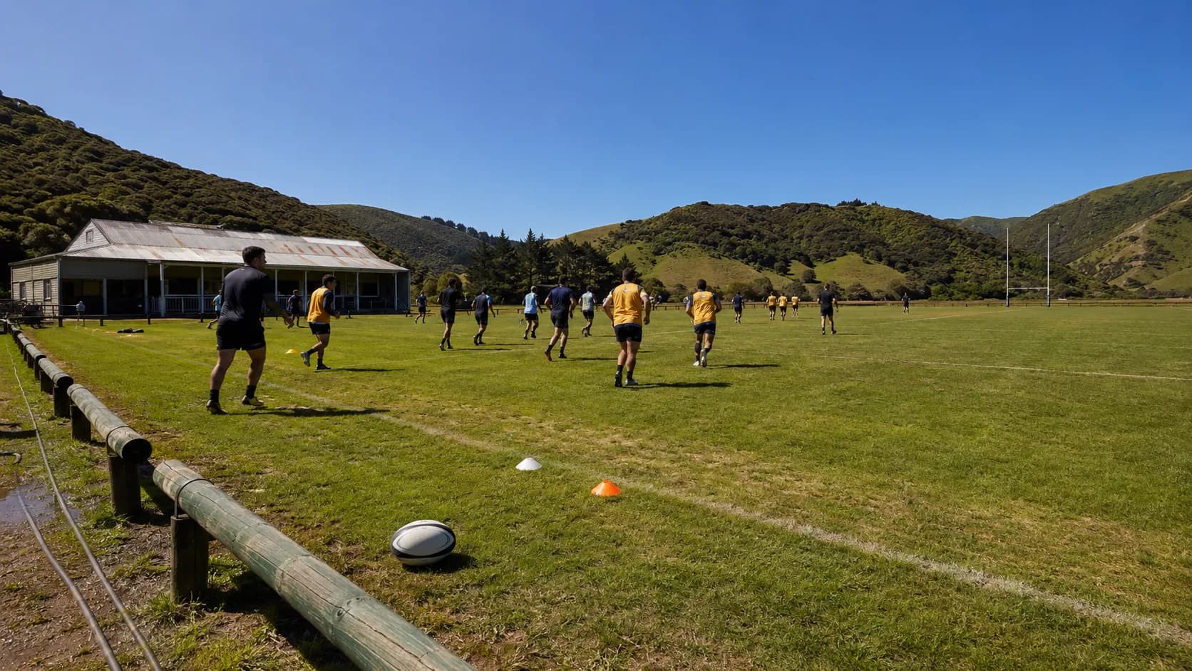 Players use a damp community sports ground beside New Zealand hills