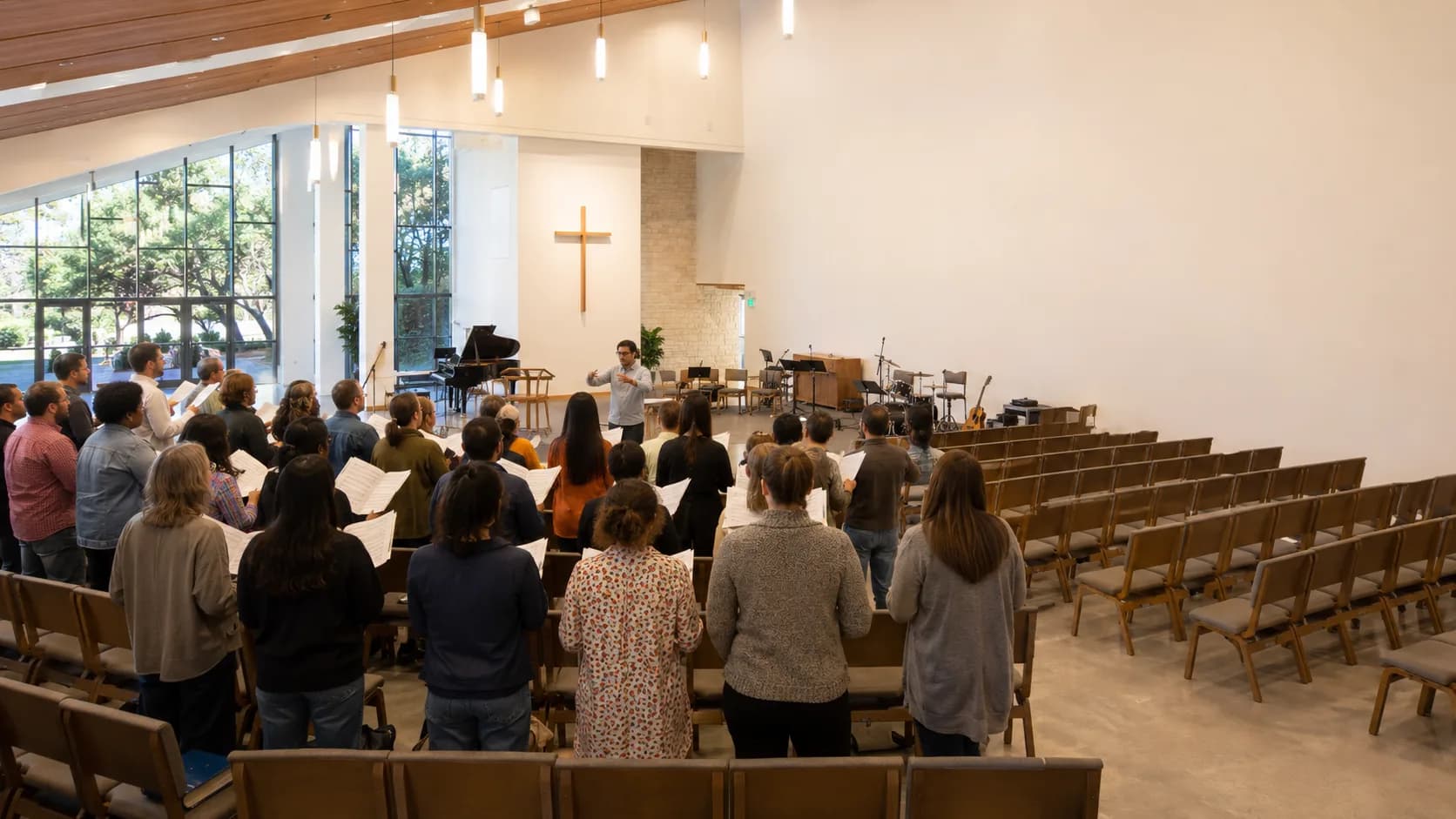 A community choir rehearses in a bright modern US sanctuary