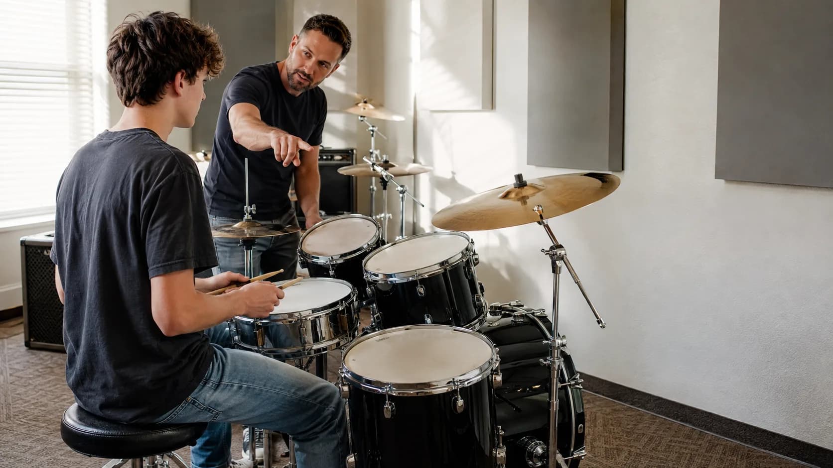 Drum instructor coaching a student at a music school in the US