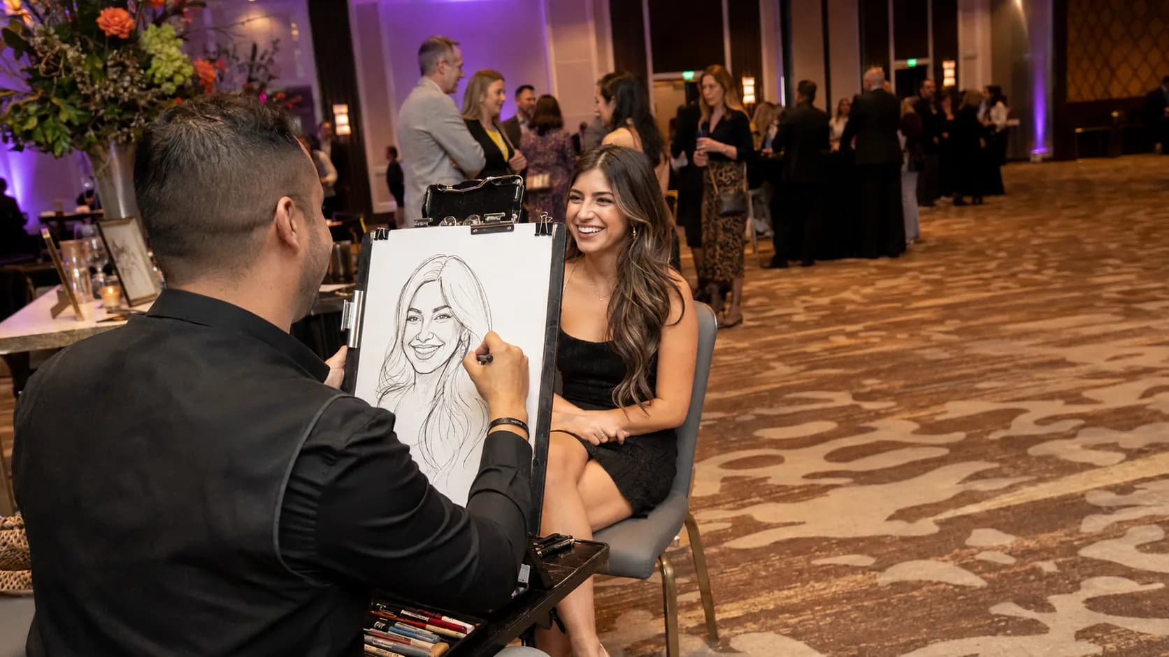 Caricaturist sketching a guest at a lively event in the US