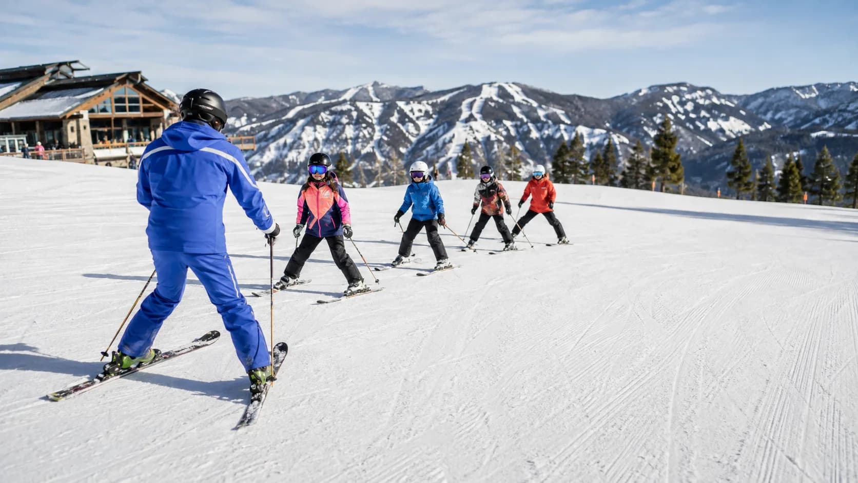 Ski school class practising turns at a mountain resort in the US