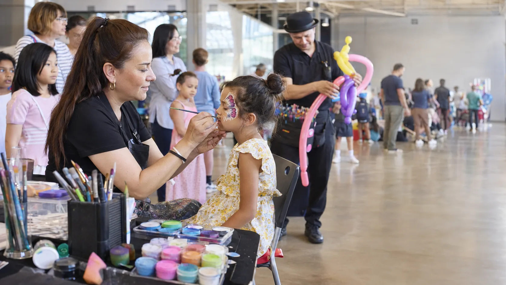 Face painter working at a busy family event in the US